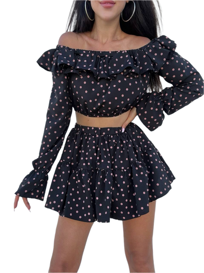 Black polka dot off-shoulder top and skirt set on a white background