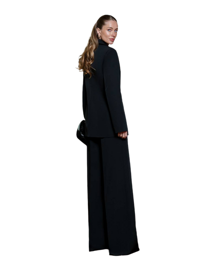 Woman wearing a black suit on a white background