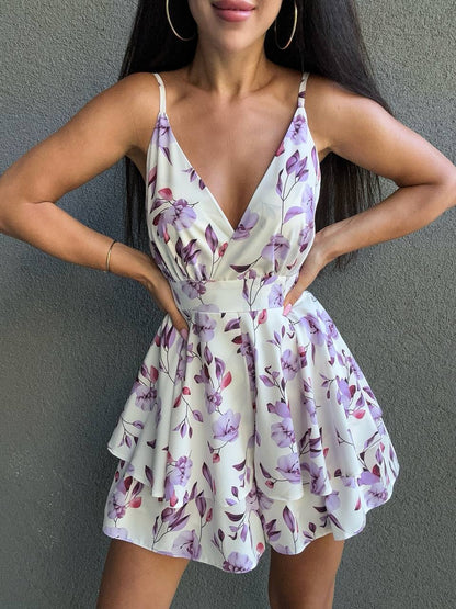 Woman wearing a floral dress against a gray background