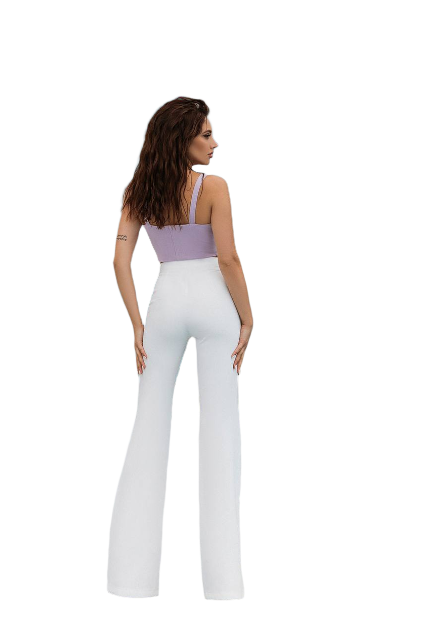 Woman wearing a lavender top and white pants on a white background