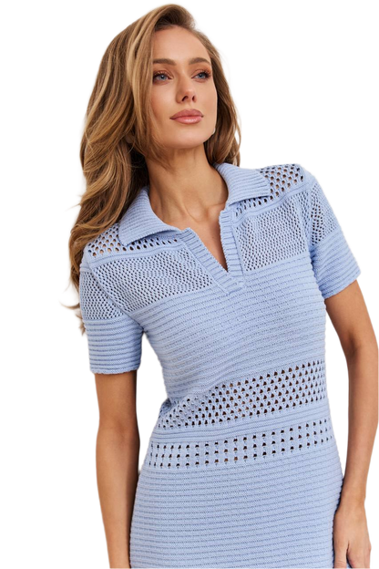 Woman wearing a light blue dress with a textured pattern on a white background