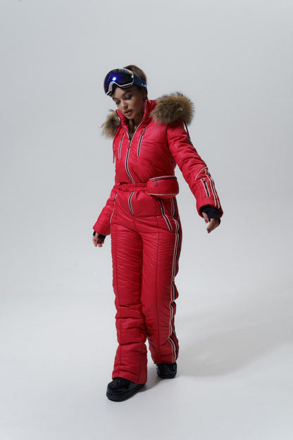 Person wearing a red ski suit with fur trim on a white background