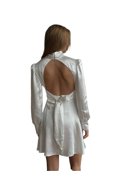 White open-back dress worn by a model on a white background