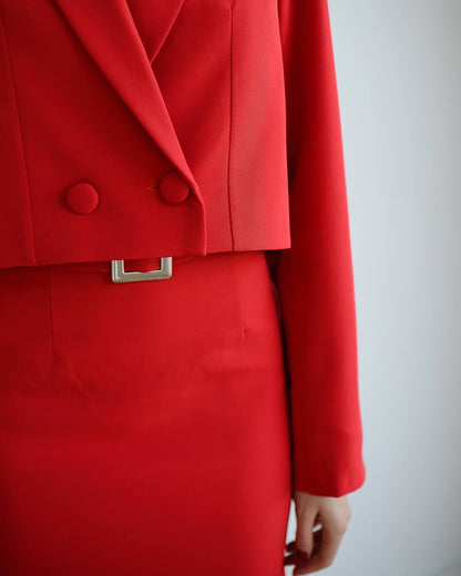 Red coat with a silver belt on a plain background