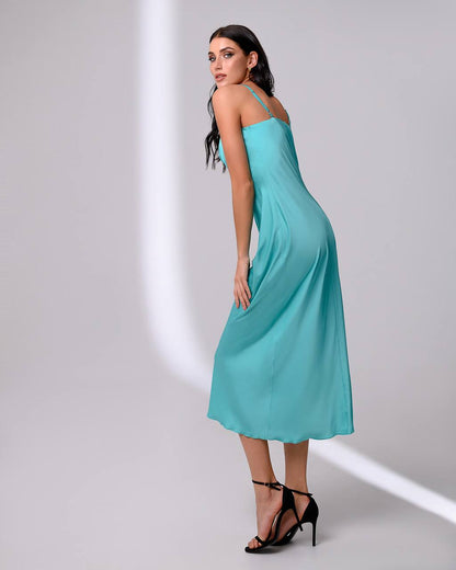 Woman wearing a turquoise dress on a white background