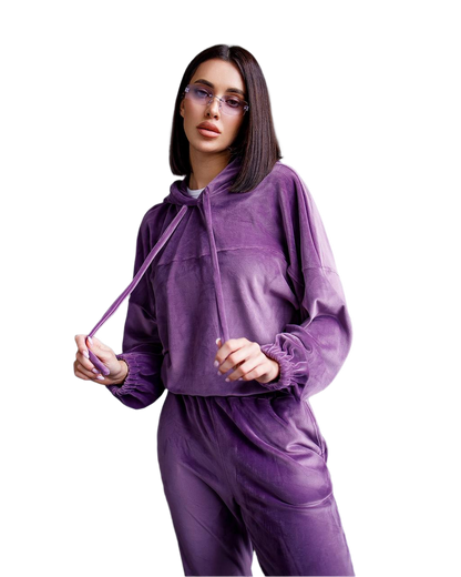 Woman wearing a purple tracksuit on a white background