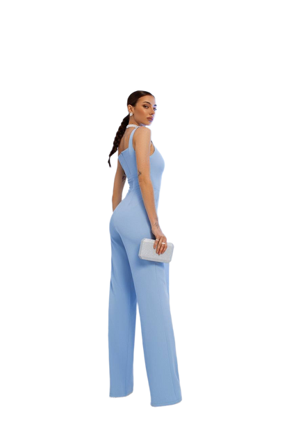 Woman wearing a light blue jumpsuit on a white background