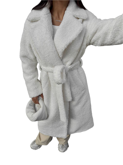 Person wearing a gray plush robe on a white background