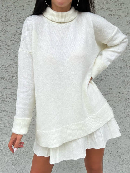 White sweater and skirt set against a gray background