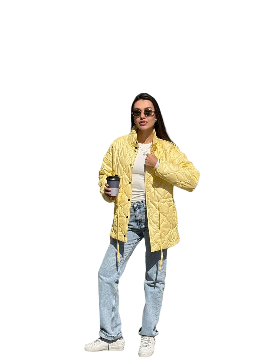 Person wearing a yellow puffer jacket holding a coffee cup on a white background