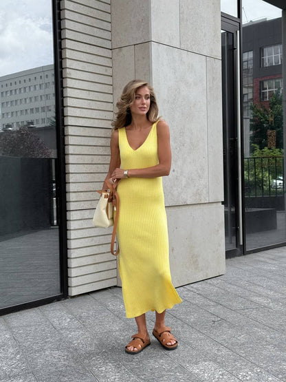 Woman in a yellow dress standing outside a building