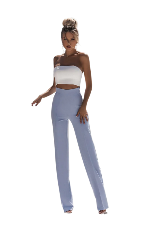 Woman wearing a white top and light blue pants on a white background