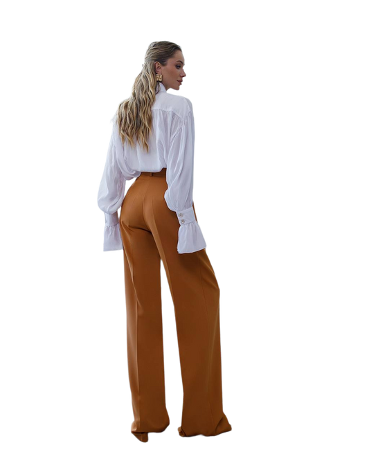 Woman wearing a white blouse and brown pants on a white background