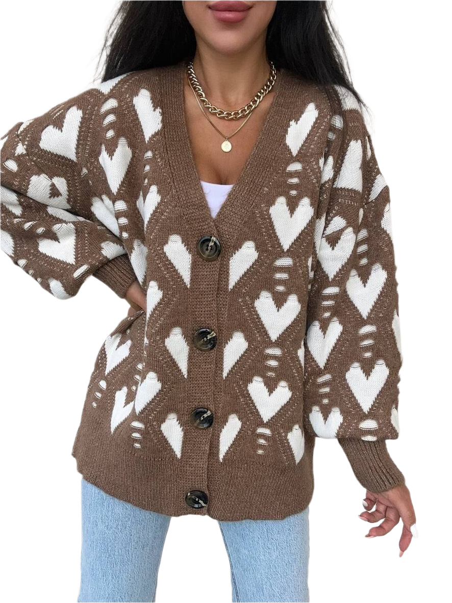 Brown cardigan with white heart pattern worn by a person on a white background