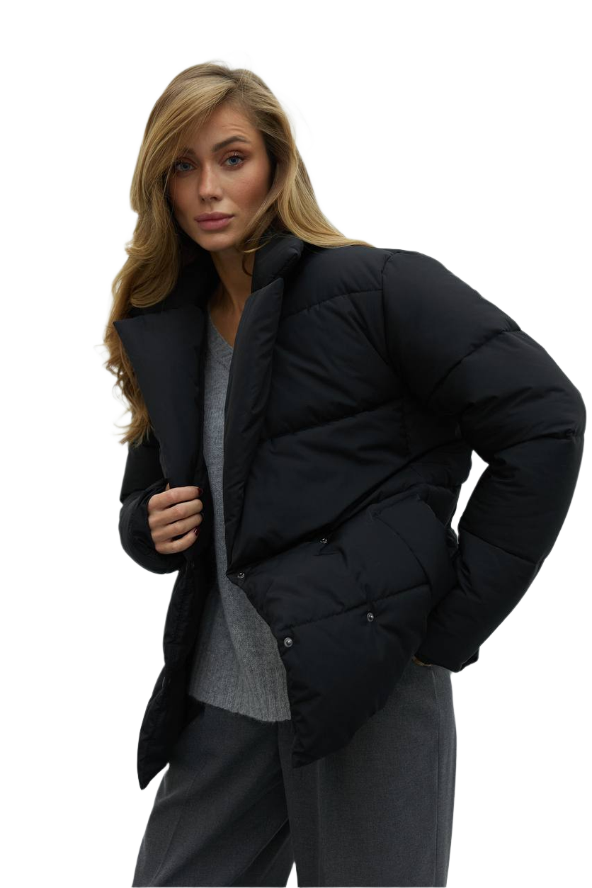 Woman wearing a black puffer jacket on a white background