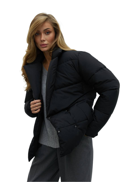 Woman wearing a black puffer jacket on a white background