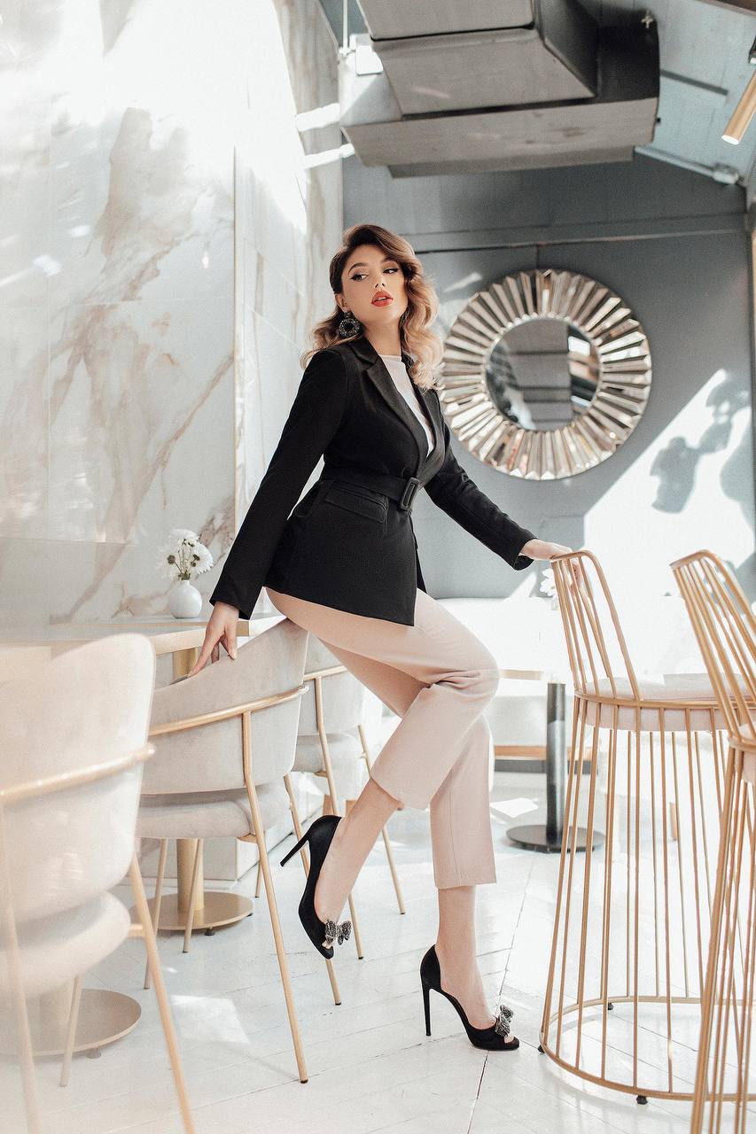 Woman in a stylish outfit posing in a modern interior setting