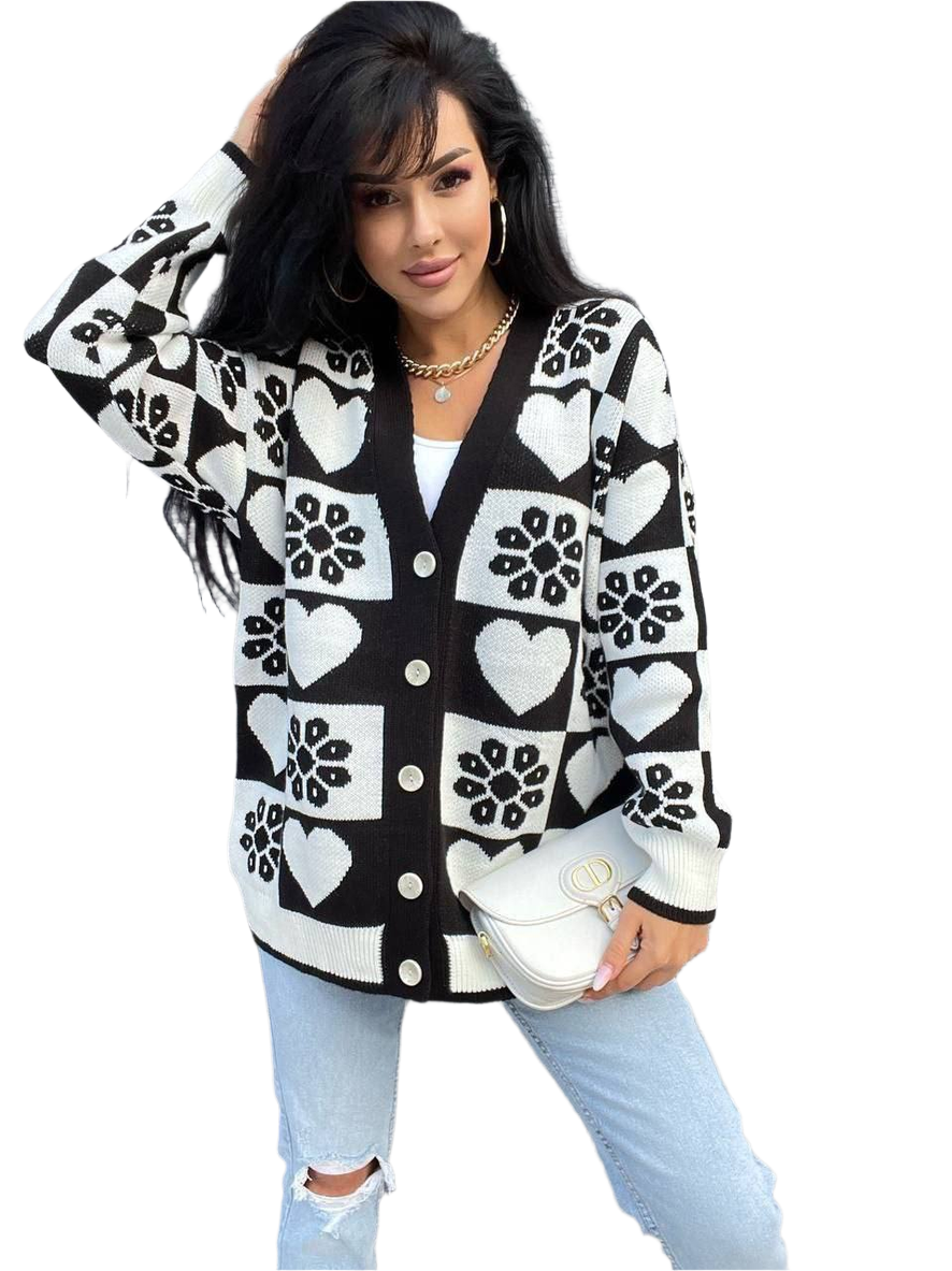 Woman wearing a black and white patterned cardigan on a white background