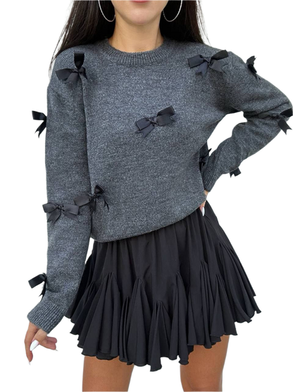 Gray sweater with black bows and a black skirt on a white background