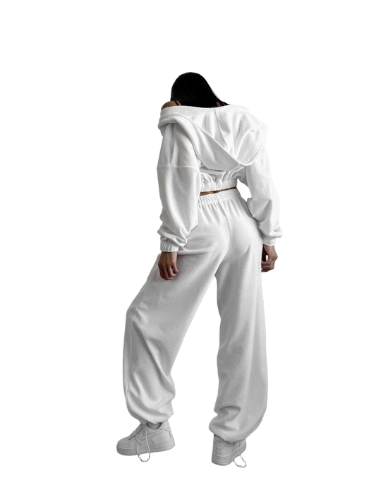 Person wearing a white tracksuit on a white background