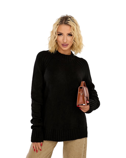 Woman wearing a black sweater holding a brown handbag on a white background