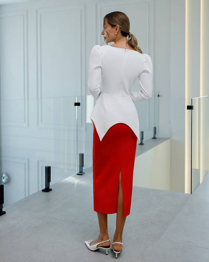 Woman wearing a white blouse and red skirt in a minimalistic room.