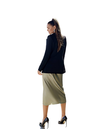 Woman wearing a black blazer and beige skirt on a white background
