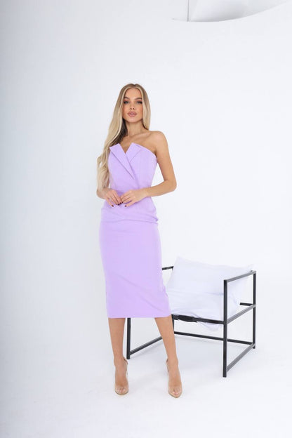 Woman wearing a light purple strapless dress against a white background