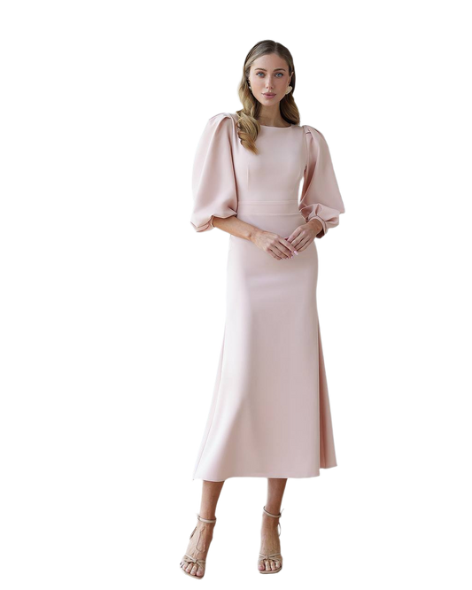 Woman wearing a light pink dress with puffed sleeves on a white background