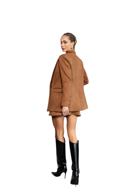 Woman wearing a brown coat and black boots on a white background