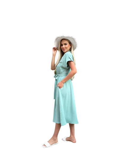 Woman wearing a light blue dress and white hat on a white background