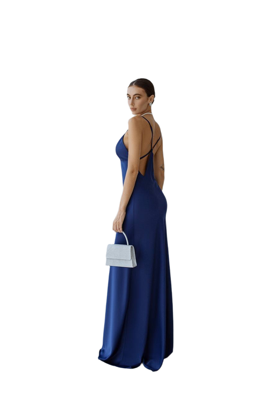 Woman wearing a blue evening gown with cut-out design on a white background