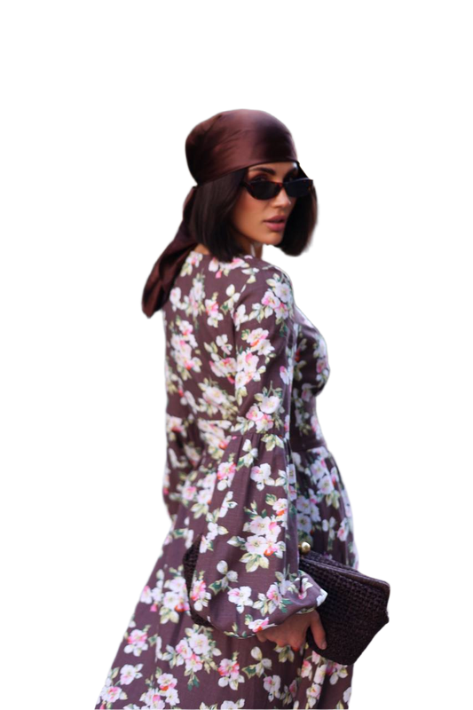 Woman wearing a floral dress and hat on a white background