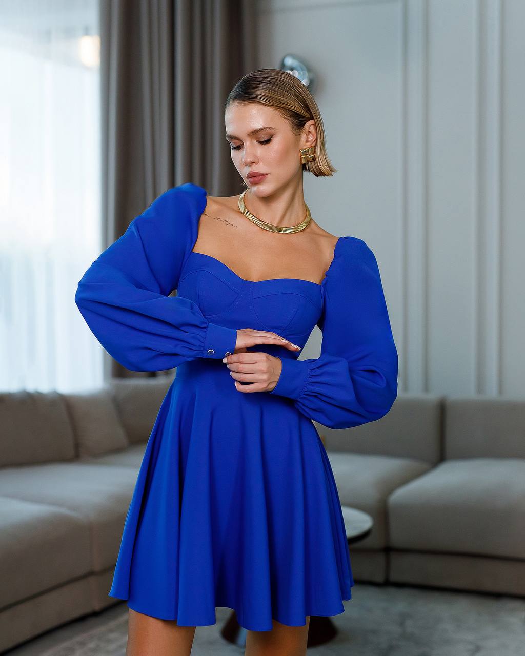 Woman wearing a blue dress in an indoor setting