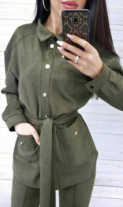 Person wearing a green jumpsuit taking a mirror selfie.