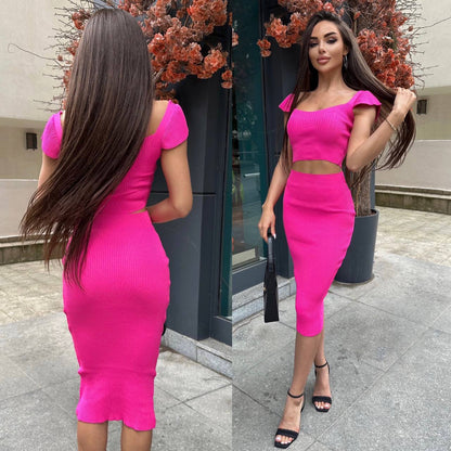 Woman wearing a bright pink dress standing outdoors.