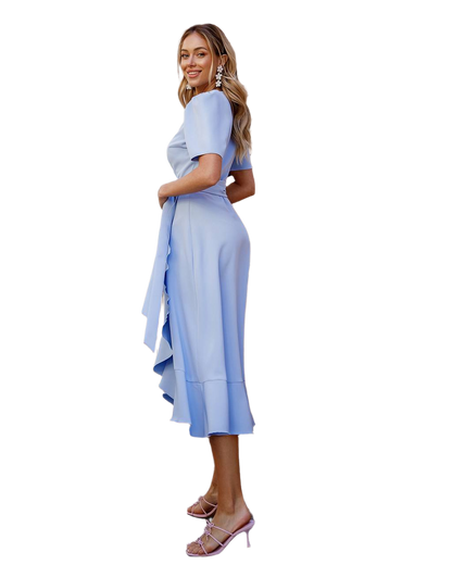 Woman wearing a light blue dress with a white background