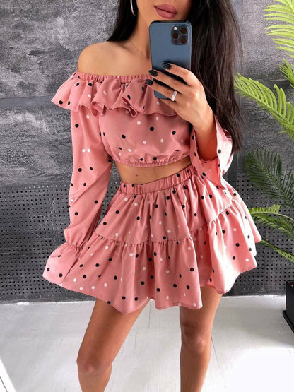 Woman wearing a pink polka dot outfit with a gray background