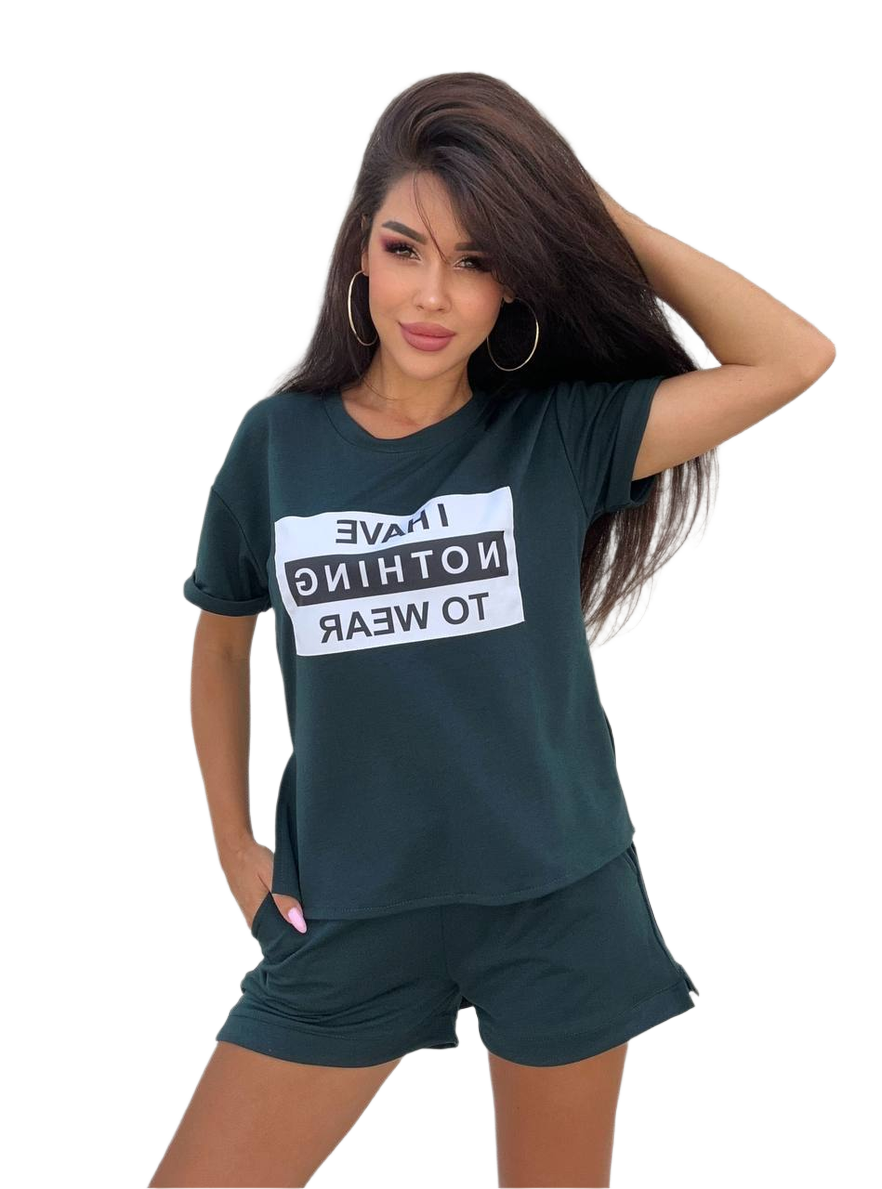 Woman wearing a dark green t-shirt with a white graphic and matching shorts on a white background