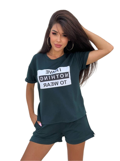 Woman wearing a dark green t-shirt with a white graphic and matching shorts on a white background