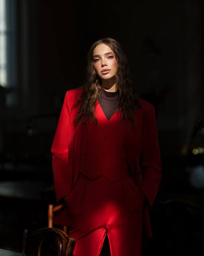 Woman wearing a red outfit in a dark setting