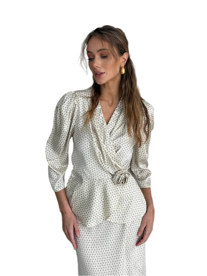 Woman wearing a polka dot dress with a belt on a white background