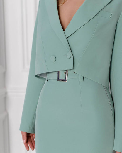 Mint green suit jacket and skirt set on a white background