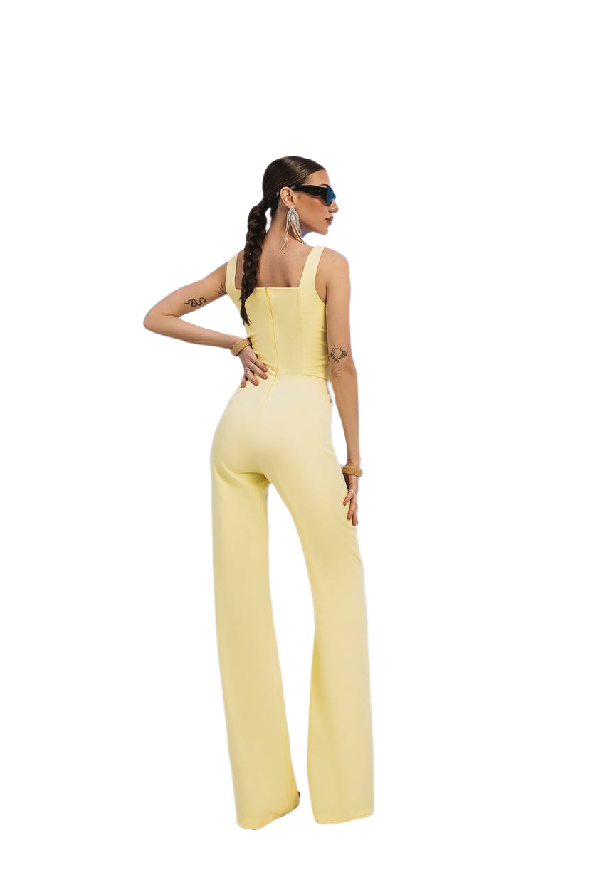 Woman wearing a yellow jumpsuit on a white background