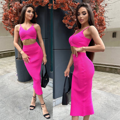 Woman wearing a bright pink dress standing outdoors.