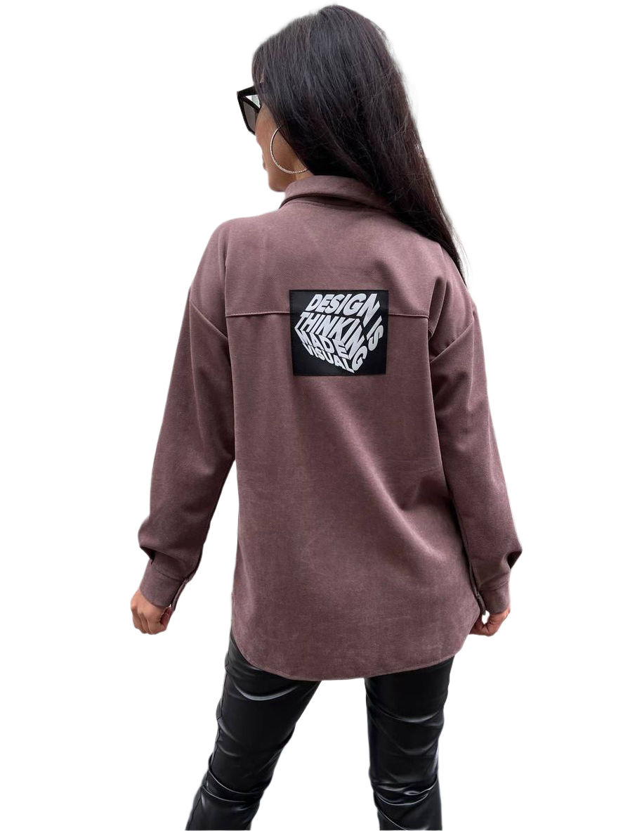 Person wearing a brown jacket with a logo on the back against a white background