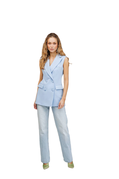 Woman wearing a light blue sleeveless blazer and pants on a white background