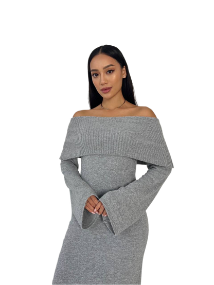 Woman wearing a gray off-shoulder dress on a white background