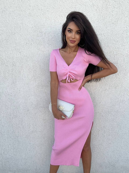 Woman wearing a pink dress against a light gray background