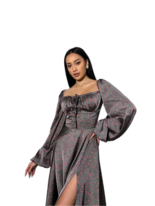 Woman wearing a gray dress with long sleeves and a slit on a white background
